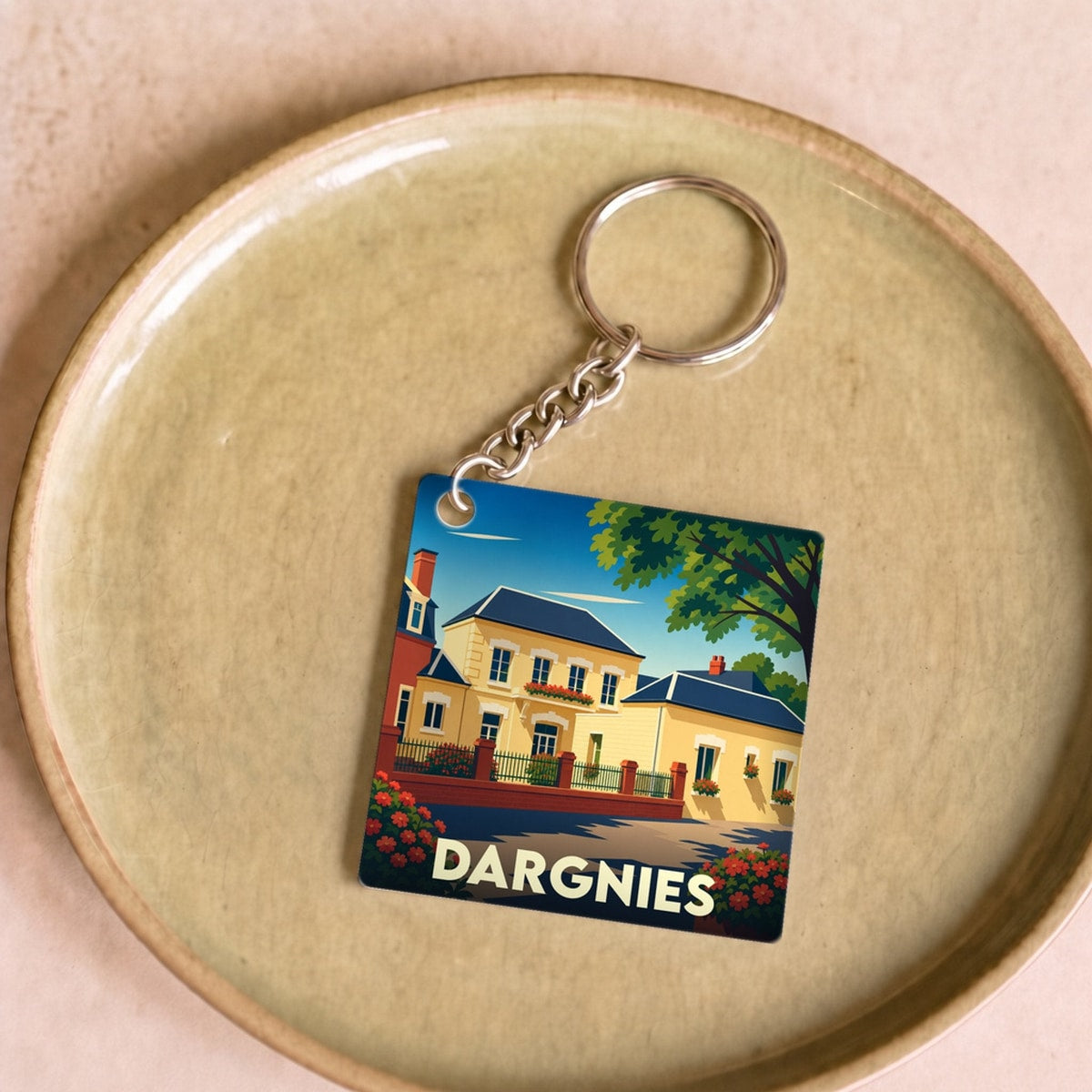Porte-clés souvenir de la ville de Dargnies avec une illustration stylisée d'une maison de maître.