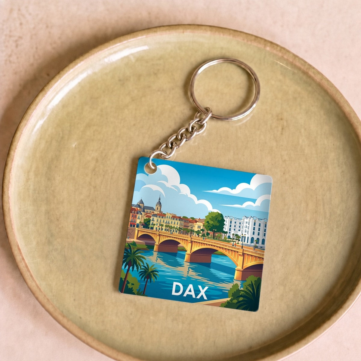 Porte-clés souvenir de la ville de Dax avec une illustration stylisée.