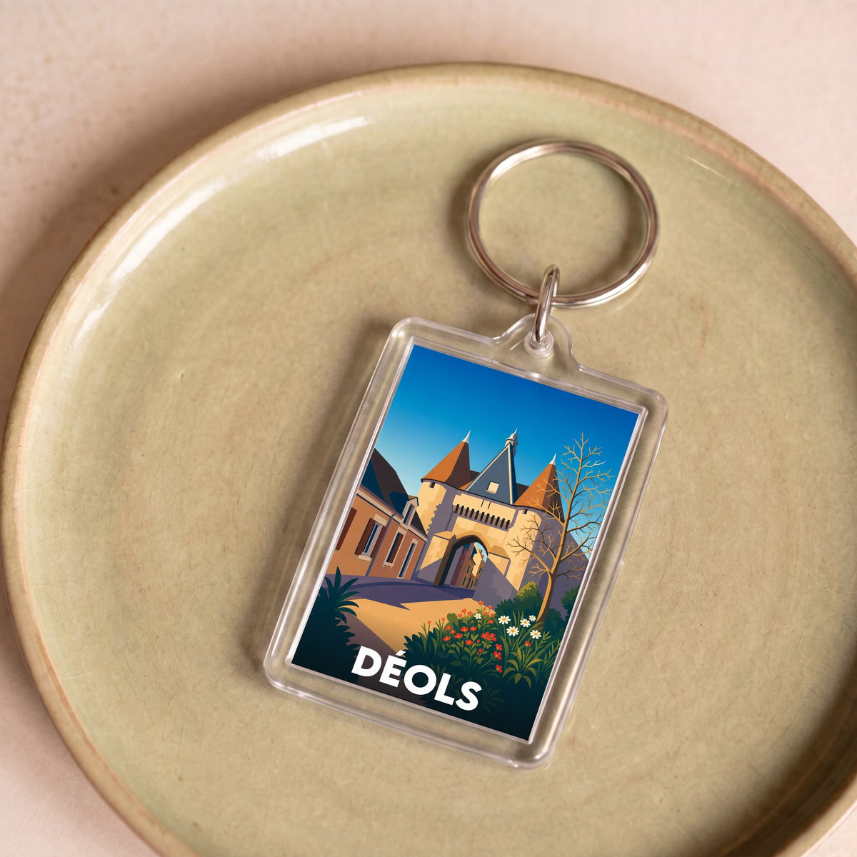 Porte-clés souvenir de la ville de Déols avec une illustration stylisée de son patrimoine.