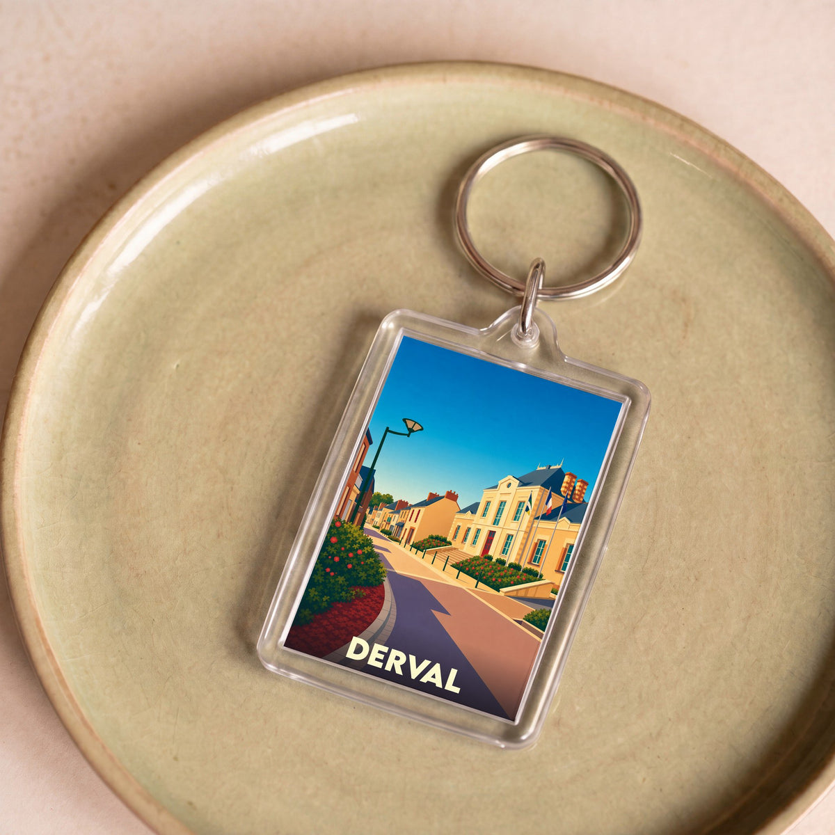 Porte-clés souvenir de la ville de Derval avec une illustration stylisée.