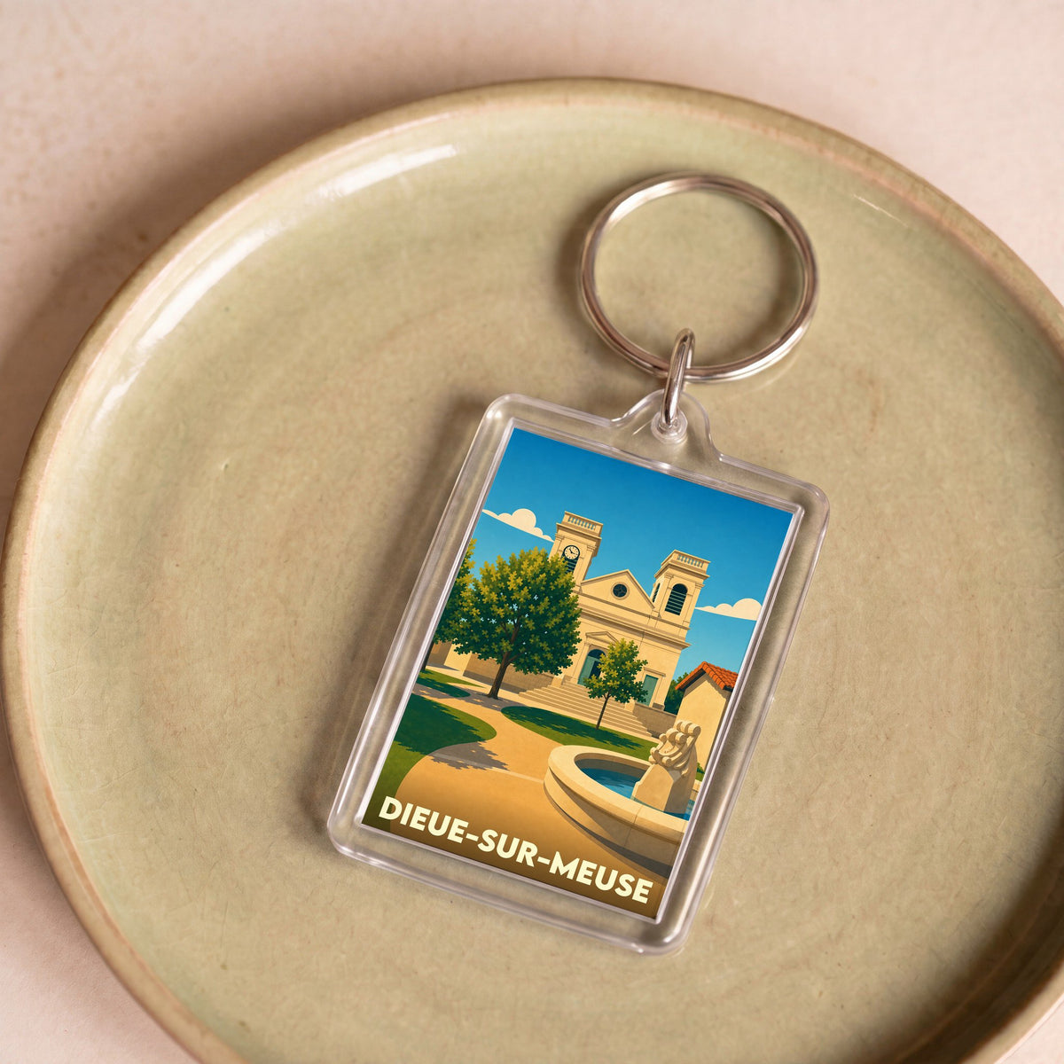 Porte-clés souvenir de la ville de Dieue-sur-Meuse avec une illustration stylisée.