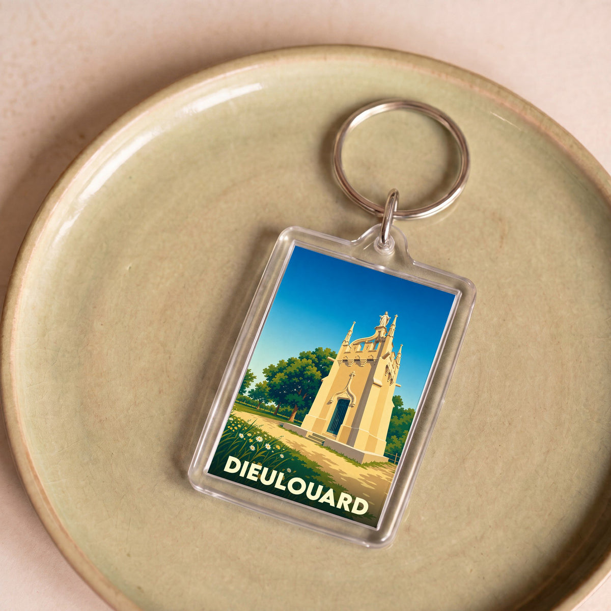 Porte-clés souvenir de la ville de Dieulouard avec une illustration stylisée d'un monument historique.