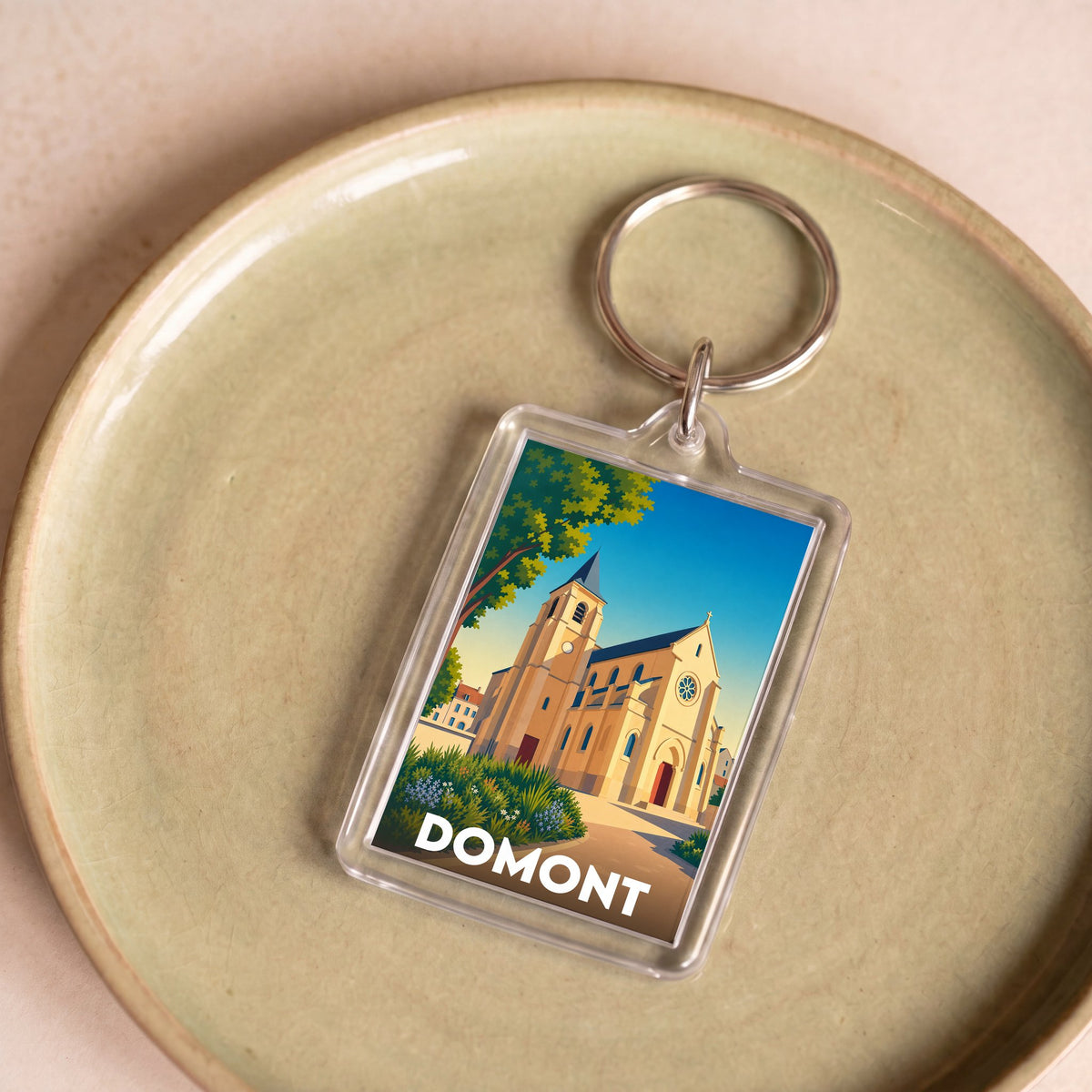 Porte-clés souvenir de la ville de Domont avec une illustration stylisée.