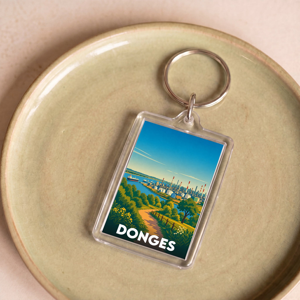 Porte-clés souvenir de la ville de Donges avec une illustration stylisée.