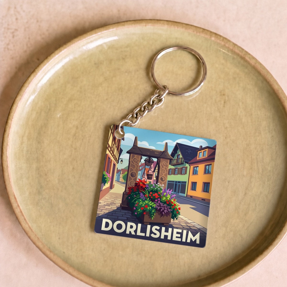 Porte-clés souvenir de la ville de Dorlisheim avec une illustration colorée et stylisée.
