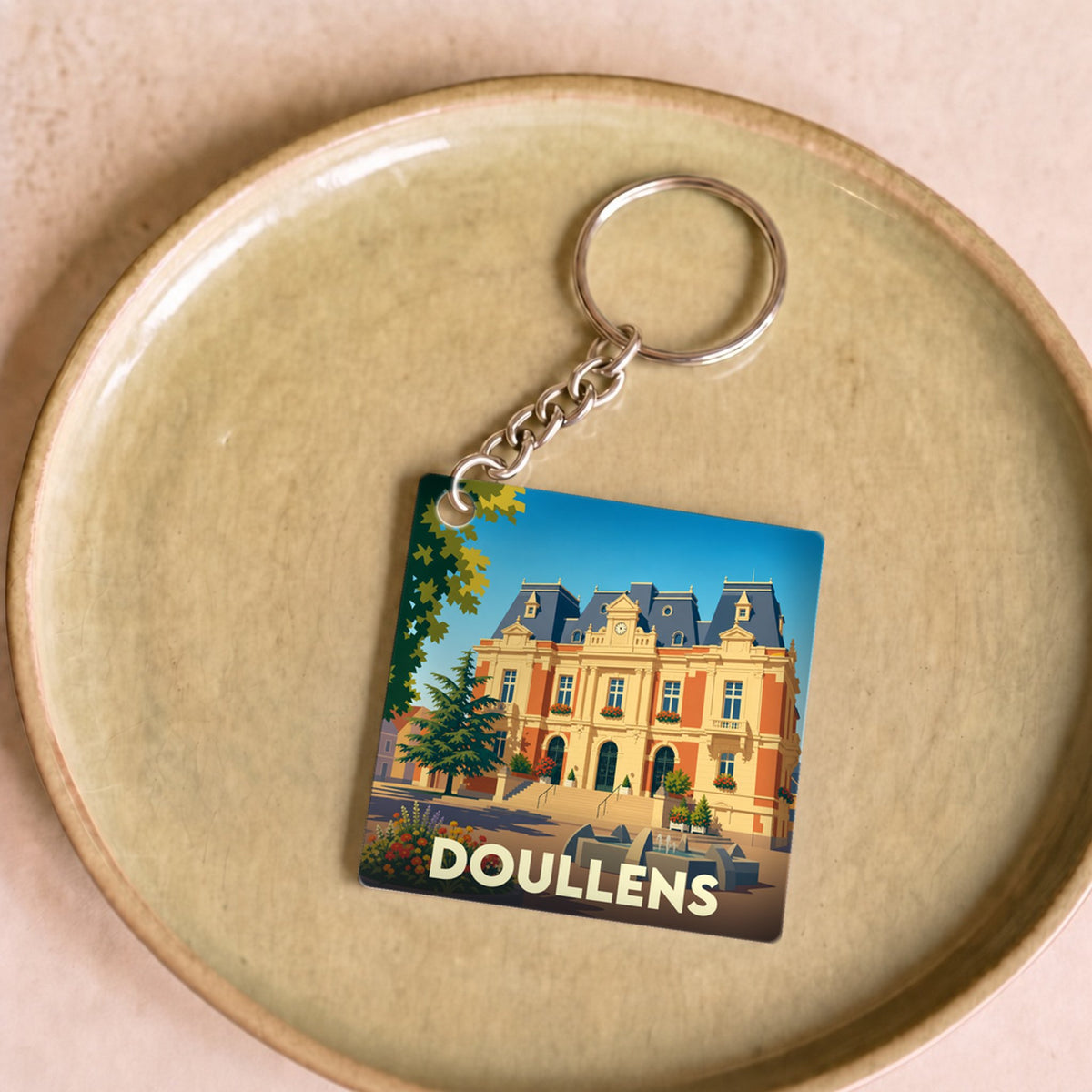 Porte-clés souvenir de la ville de Doullens avec une illustration stylisée de son hôtel de ville.