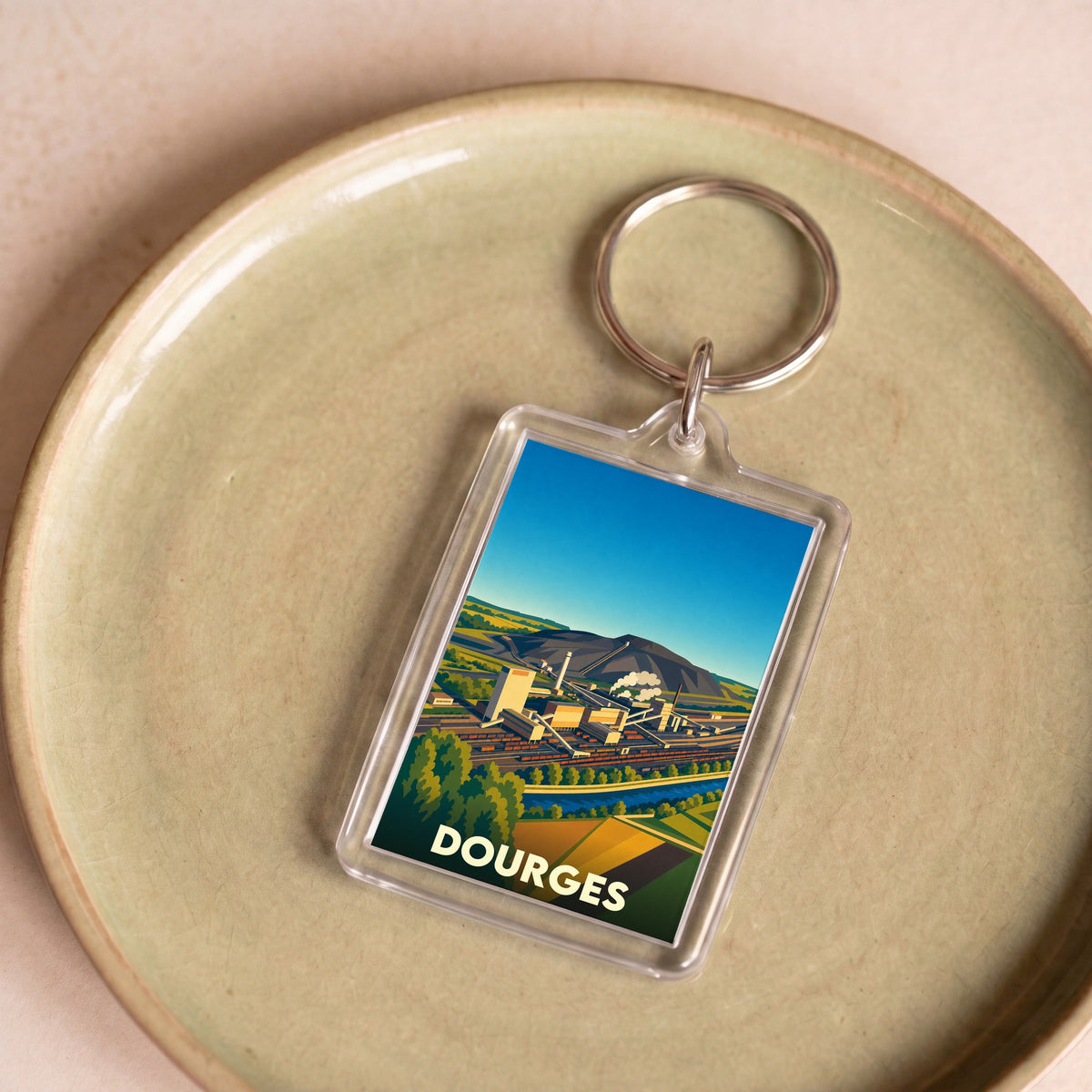 Porte-clés souvenir de la ville de Dourges avec une illustration stylisée.