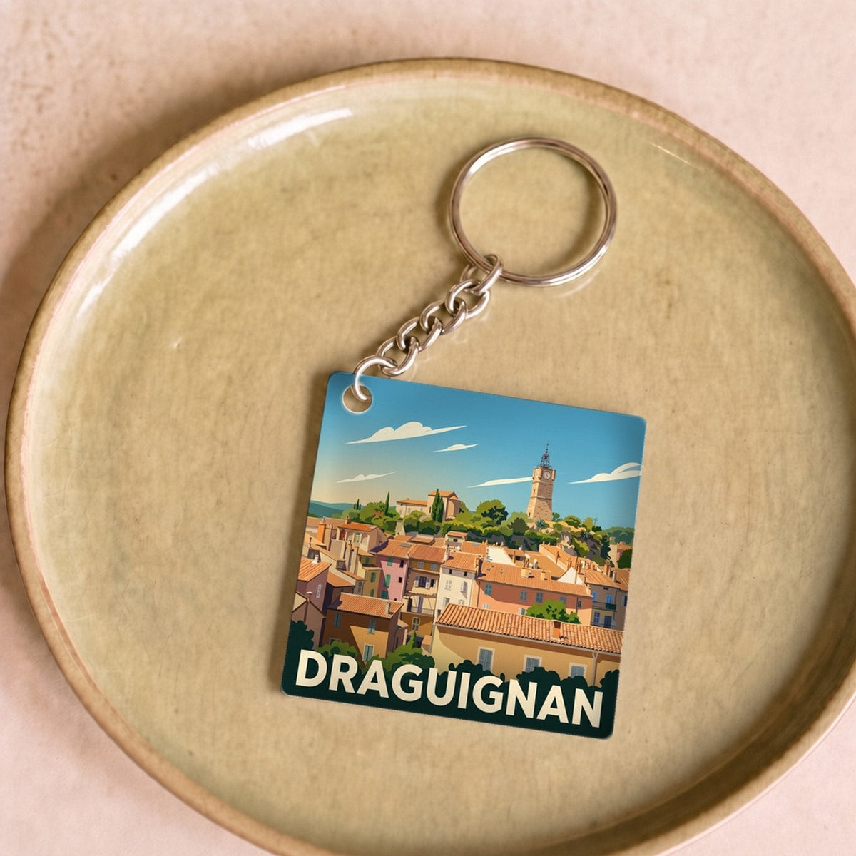 Porte-clés souvenir de la ville de Draguignan avec une illustration stylisée.