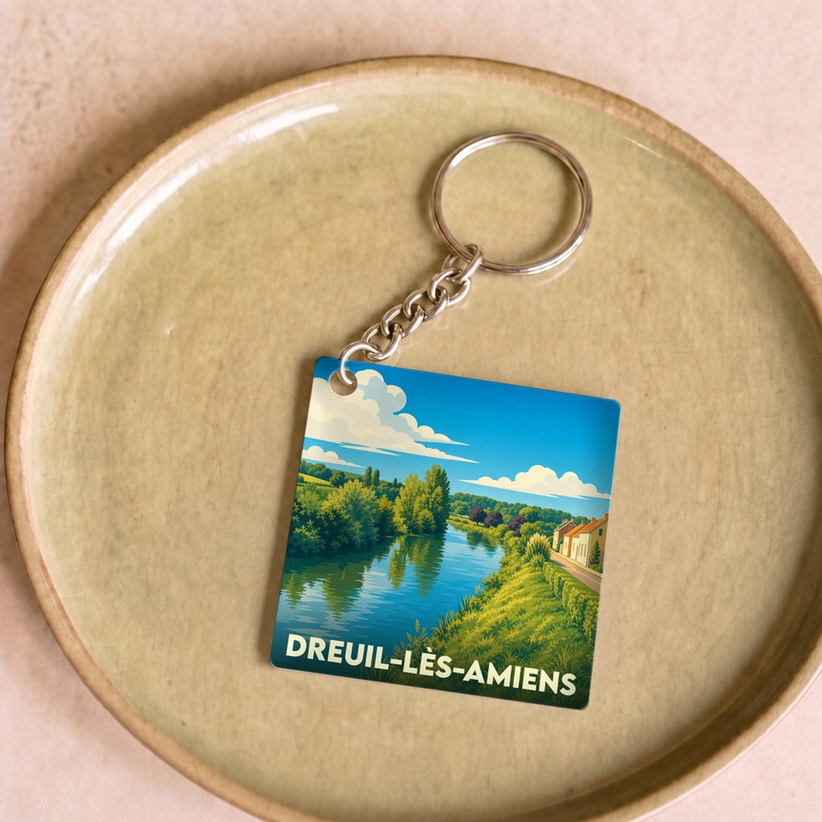 Porte-clés souvenir de la ville de Dreuil-lès-Amiens avec une illustration stylisée des bords de Somme.