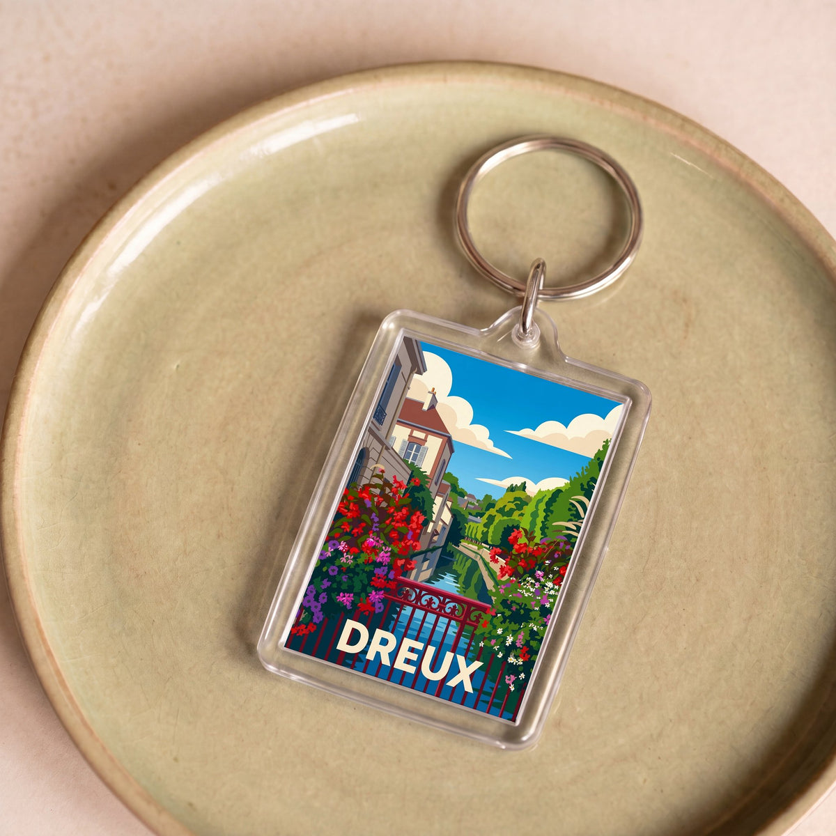 Porte-clés souvenir de la ville de Dreux avec une illustration stylisée et colorée.
