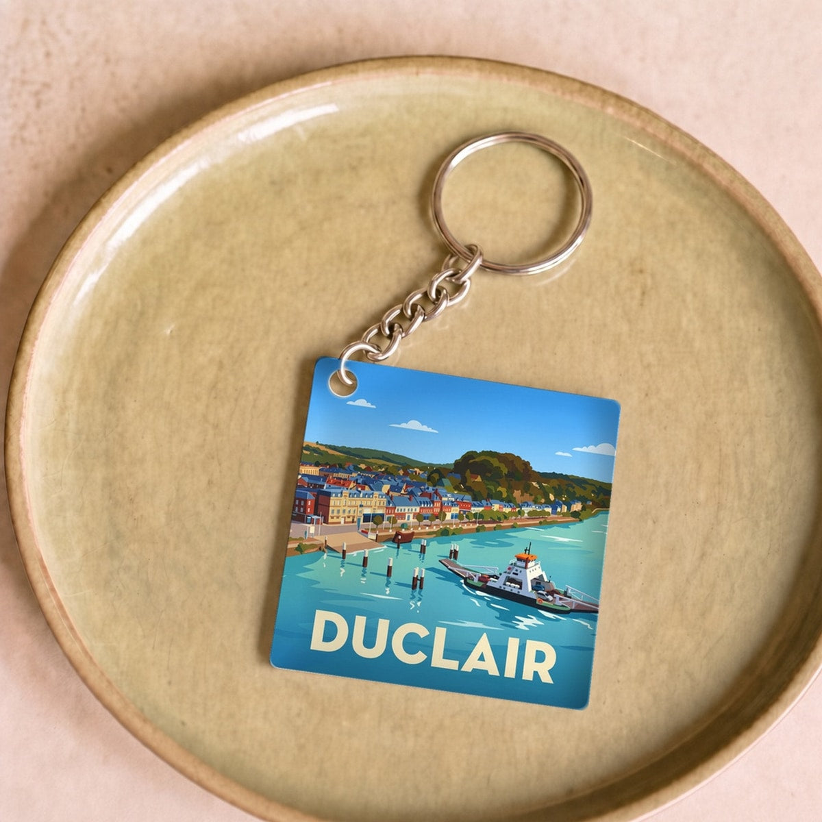 Porte-clés souvenir de la ville de Duclair avec une illustration stylisée.