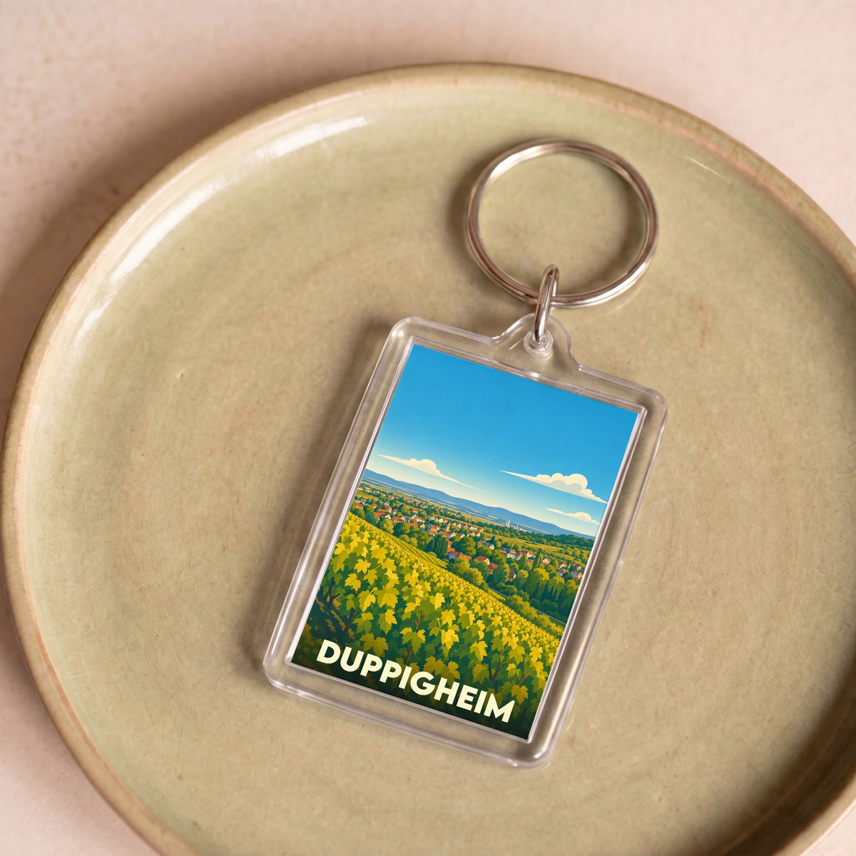 Porte-clés souvenir de la ville de Duppigheim avec une illustration stylisée de vignobles.