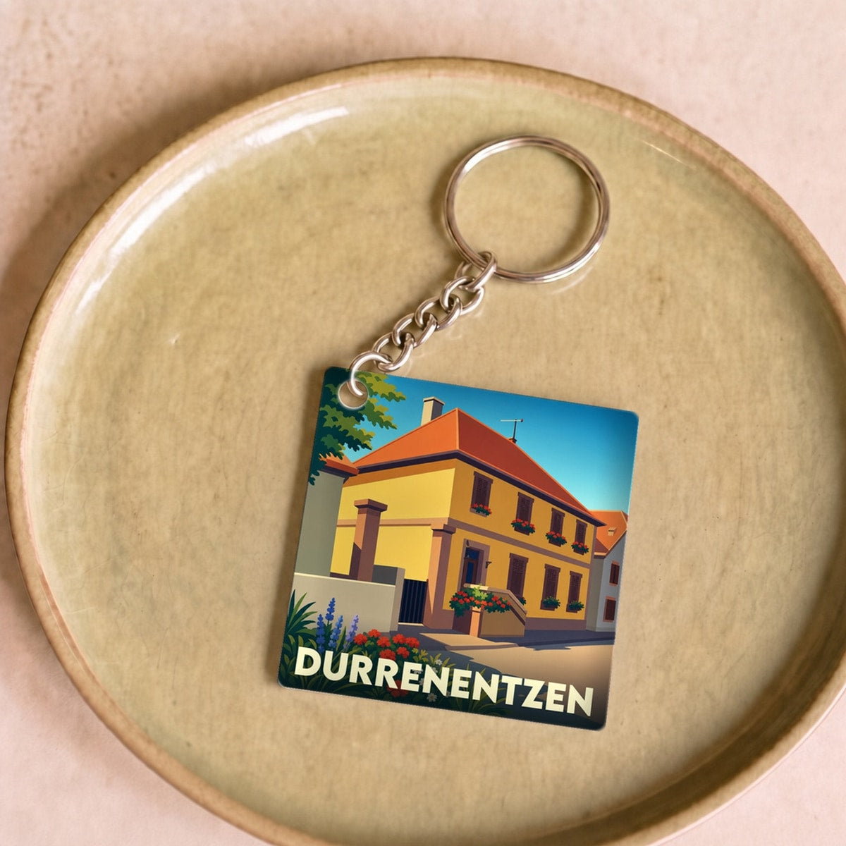 Porte-clés souvenir de la ville de Durrenentzen avec une illustration stylisée.