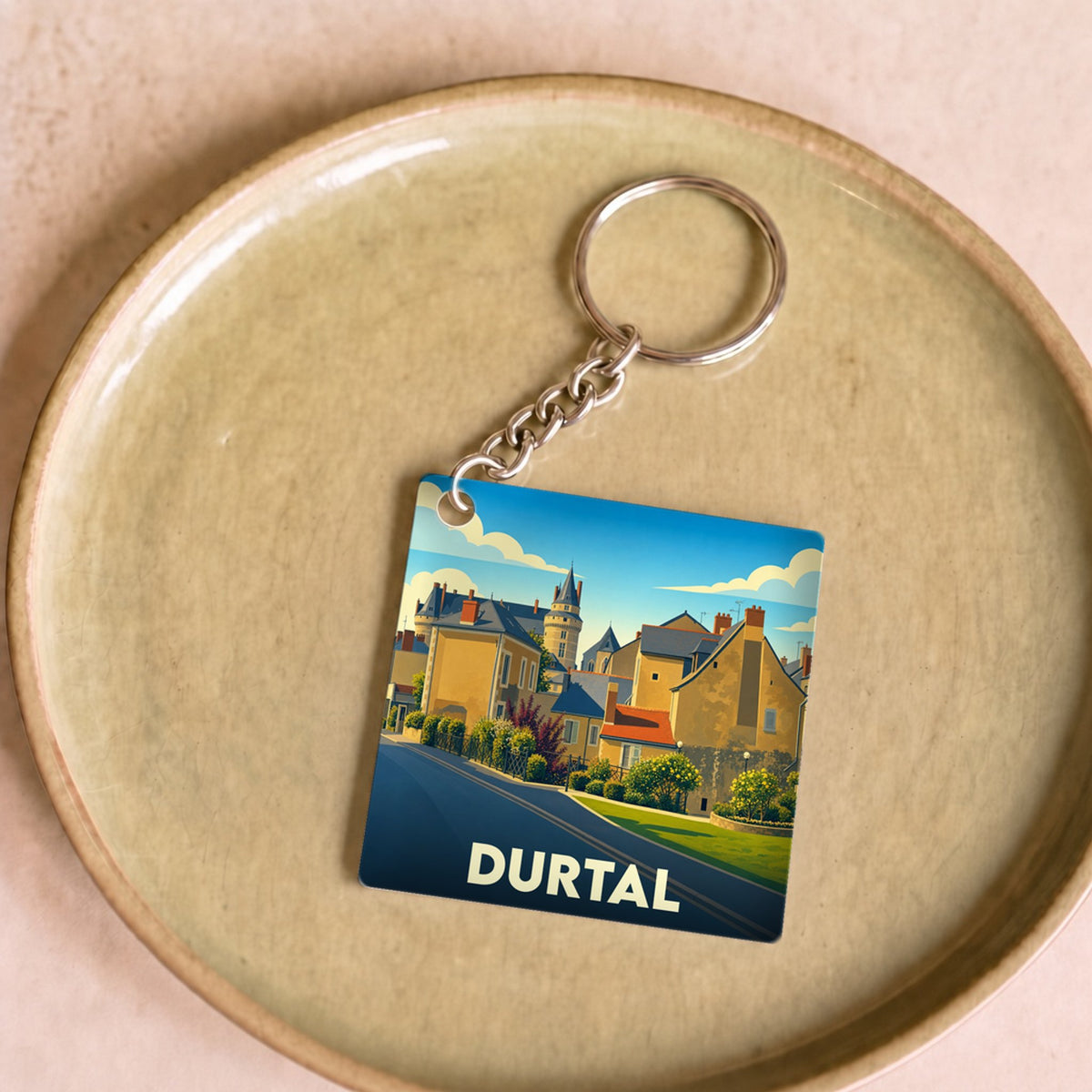 Porte-clés souvenir de la ville de Durtal avec une illustration stylisée.