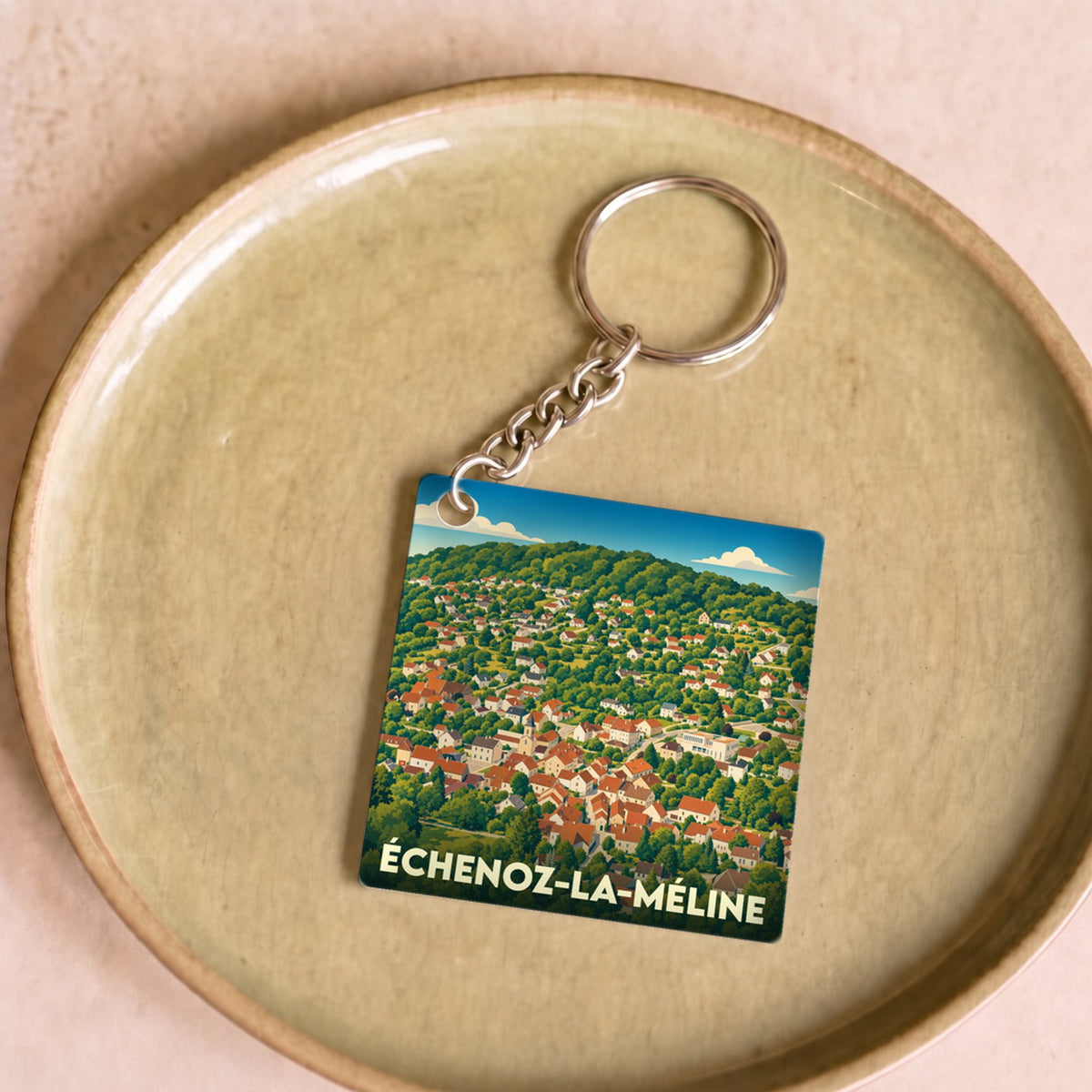 Porte-clés souvenir de la ville de Échenoz-la-Méline avec une illustration stylisée.