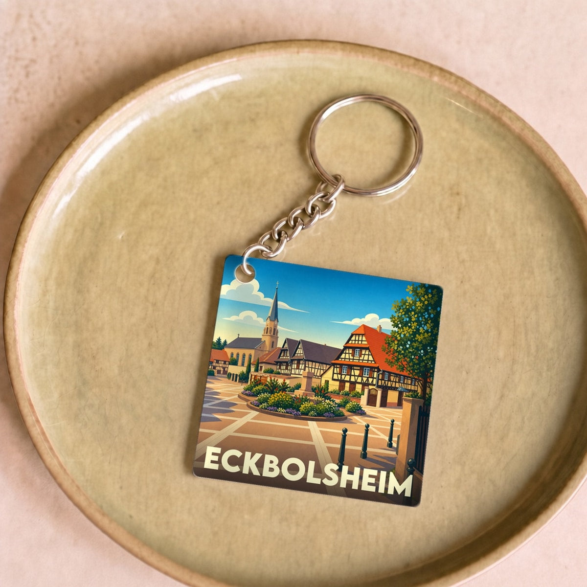 Porte-clés souvenir de la ville de Eckbolsheim avec une illustration stylisée.