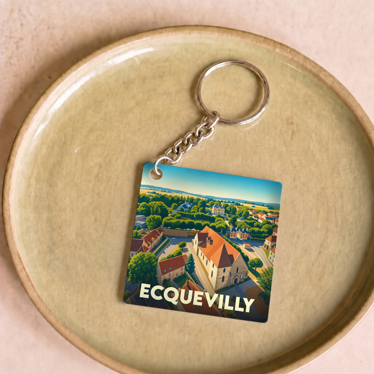 Porte-clés souvenir de la ville de Ecquevilly avec une illustration stylisée.