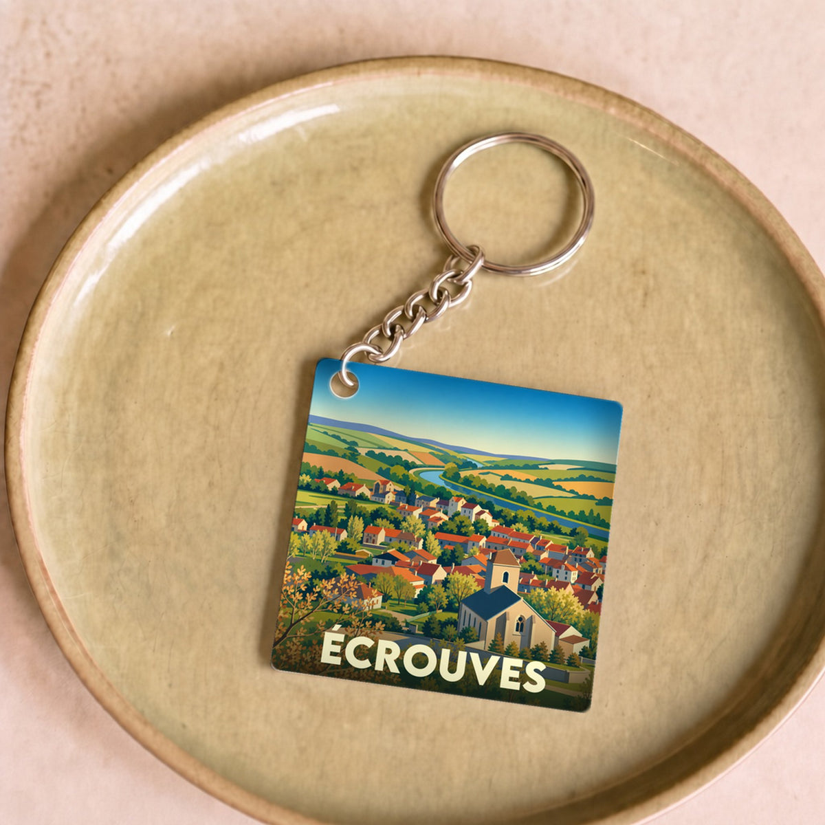 Porte-clés souvenir de la ville d'Écrouves avec une illustration stylisée.