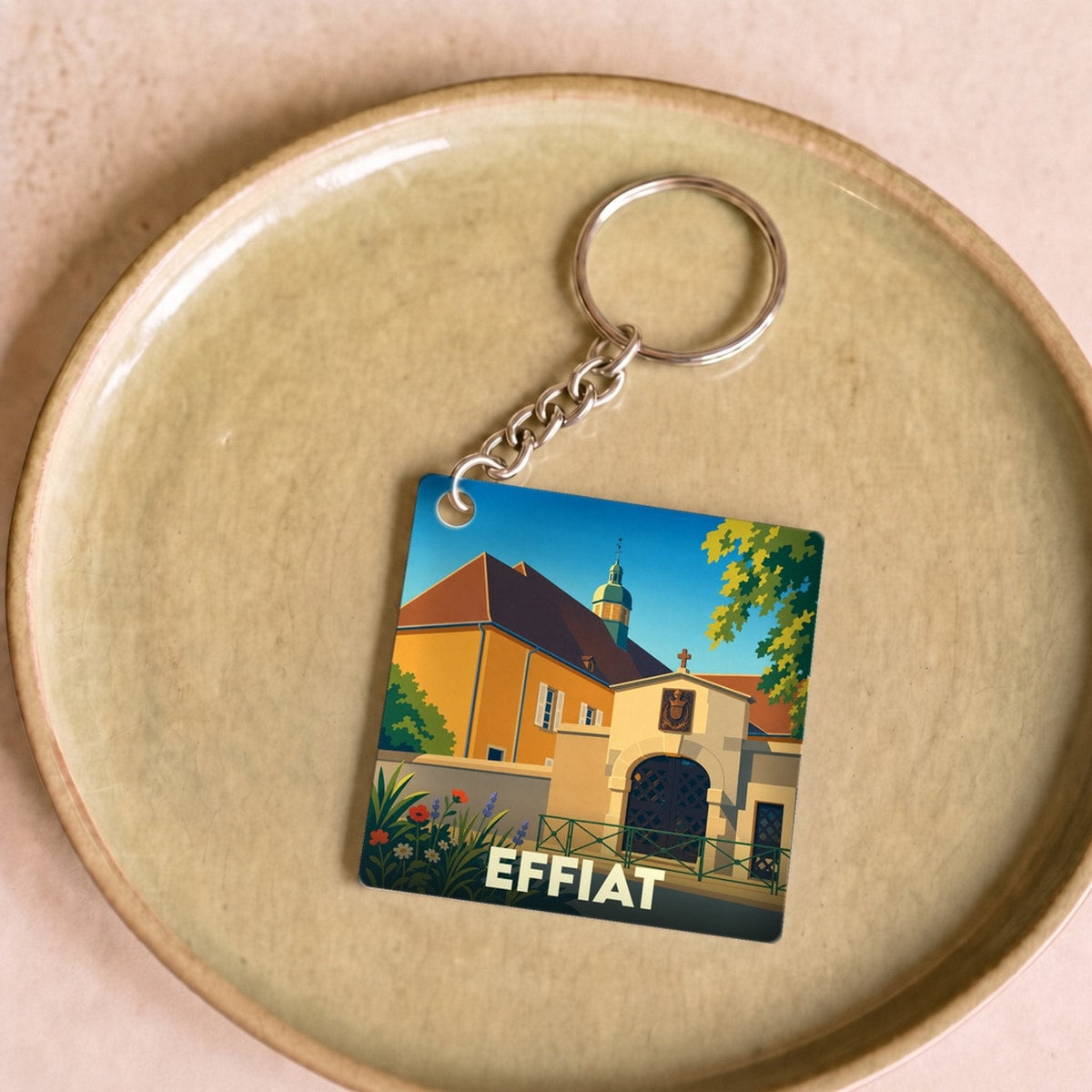Porte-clés souvenir de la ville d'Effiat avec une illustration stylisée.