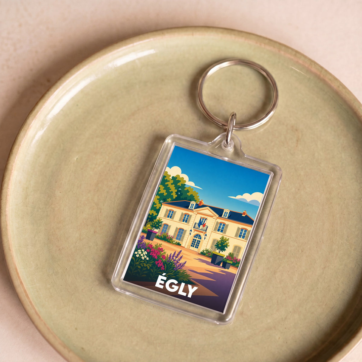 Porte-clés souvenir de la ville d'Égly avec une illustration stylisée.