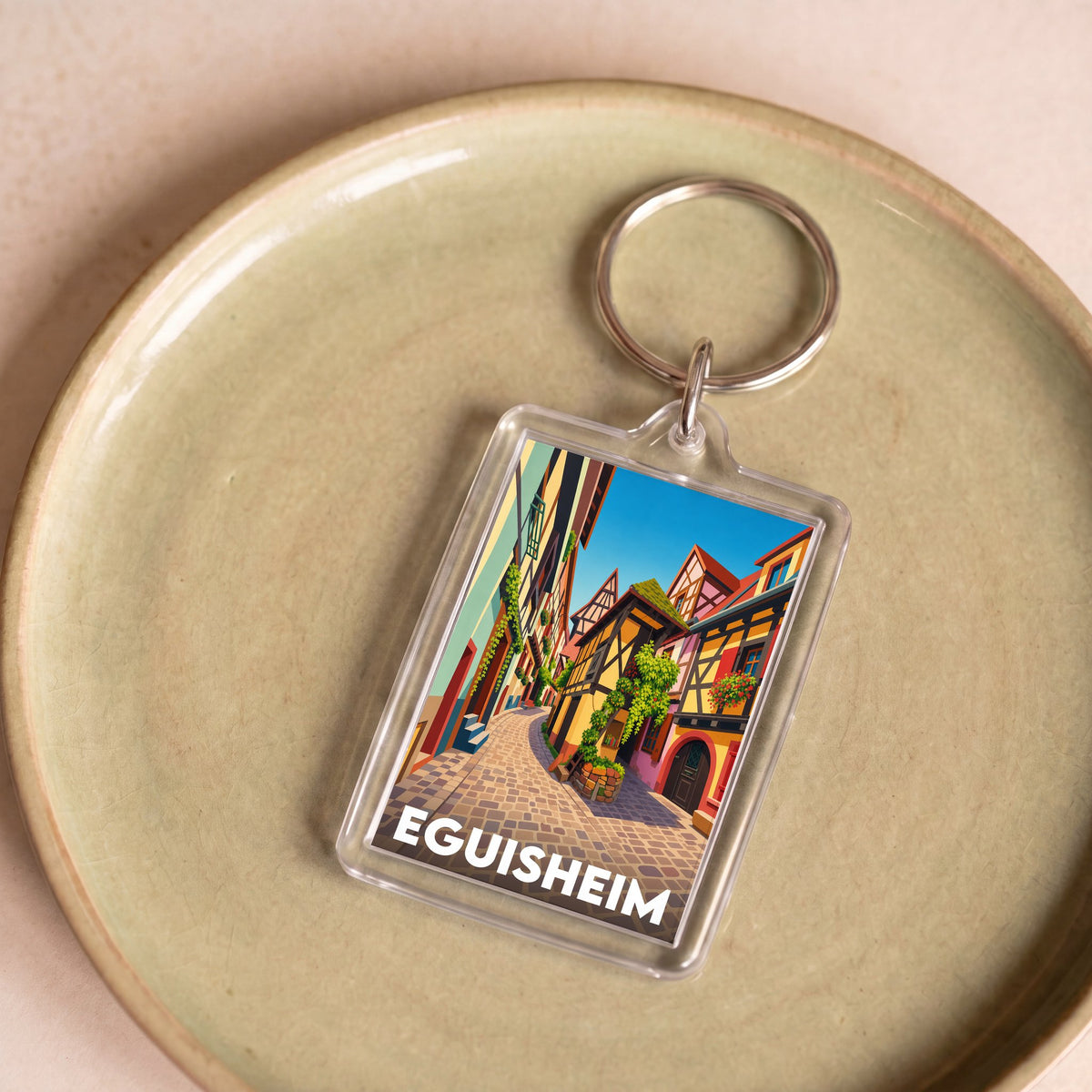 Porte-clés souvenir de la ville d'Eguisheim avec une illustration stylisée.