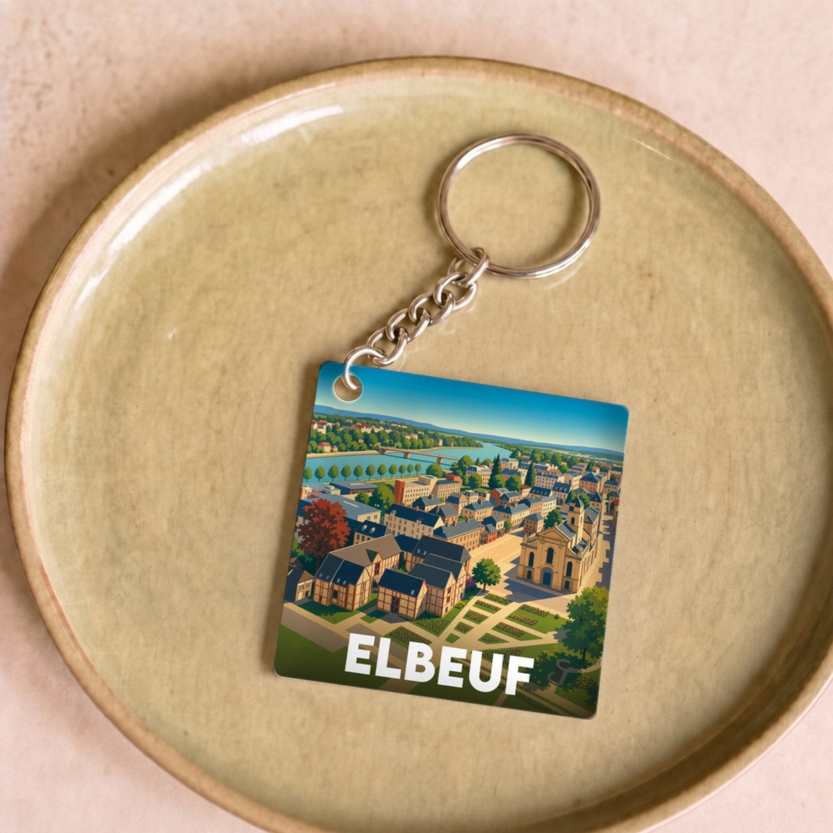 Porte-clés souvenir de la ville d'Elbeuf avec une illustration stylisée.