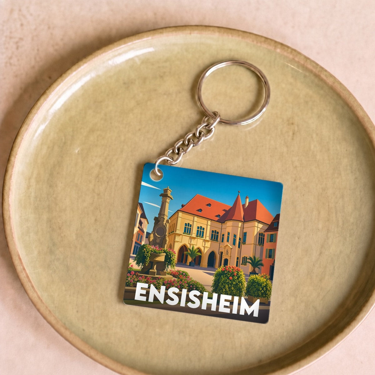 Porte-clés souvenir de la ville d'Ensisheim avec une illustration stylisée.
