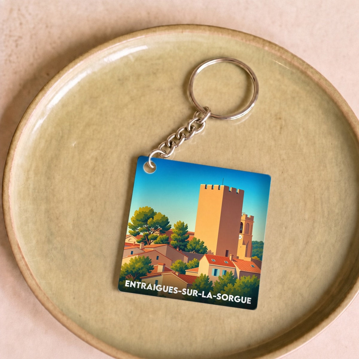 Porte-clés souvenir de la ville de Entraigues-sur-la-Sorgue avec une illustration stylisée.