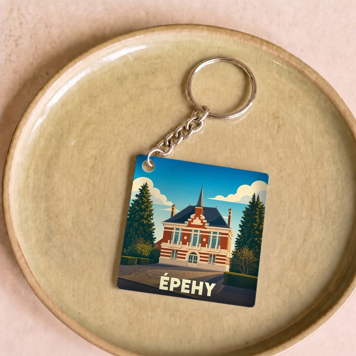 Porte-clés souvenir de la ville d'Épehy avec une illustration stylisée de son hôtel de ville.