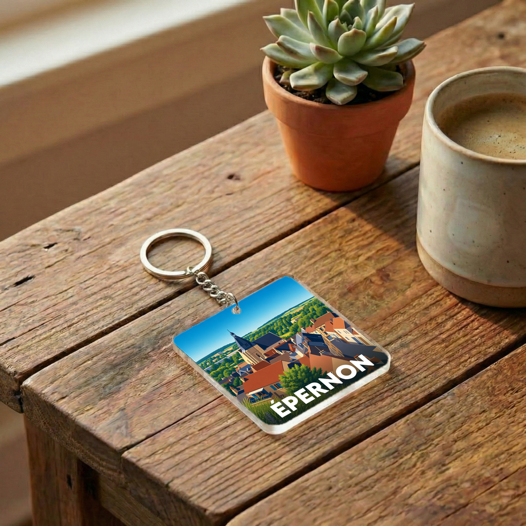 Porte-clés souvenir de la ville d'Épernon avec une illustration stylisée de son paysage urbain.