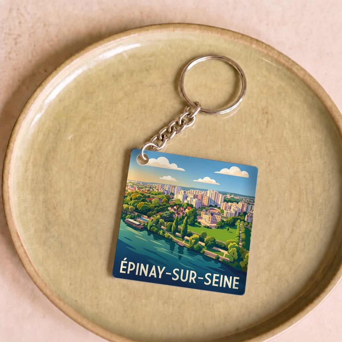 Porte-clés souvenir de la ville d'Épinay-sur-Seine avec une illustration stylisée.