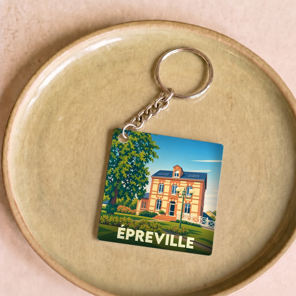 Porte-clés souvenir de la ville de Épreville avec une illustration stylisée.