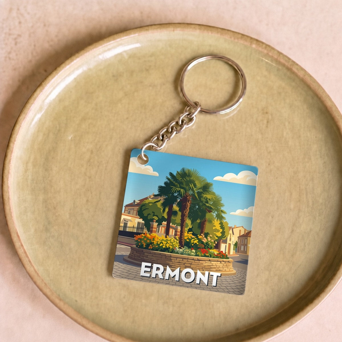 Porte-clés souvenir de la ville d'Ermont avec une illustration stylisée.