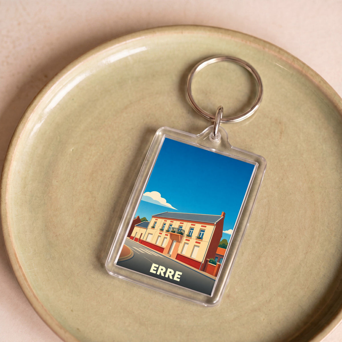 Porte-clés souvenir de la ville de Erre avec une illustration stylisée.