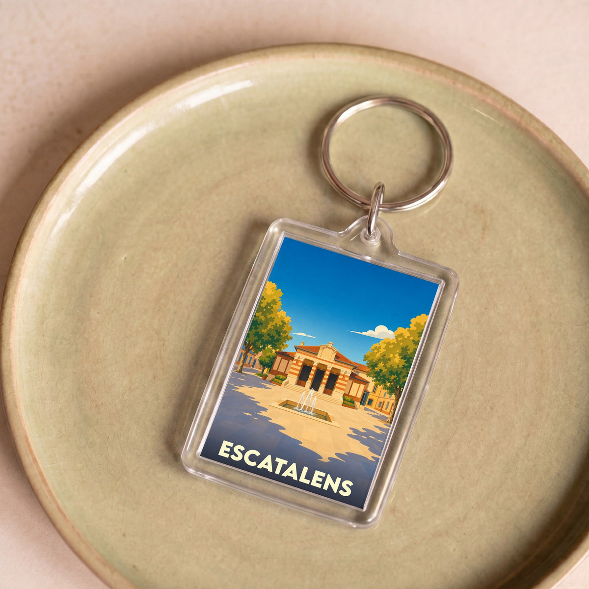 Porte-clés souvenir de la ville d'Escatalens avec une illustration stylisée.