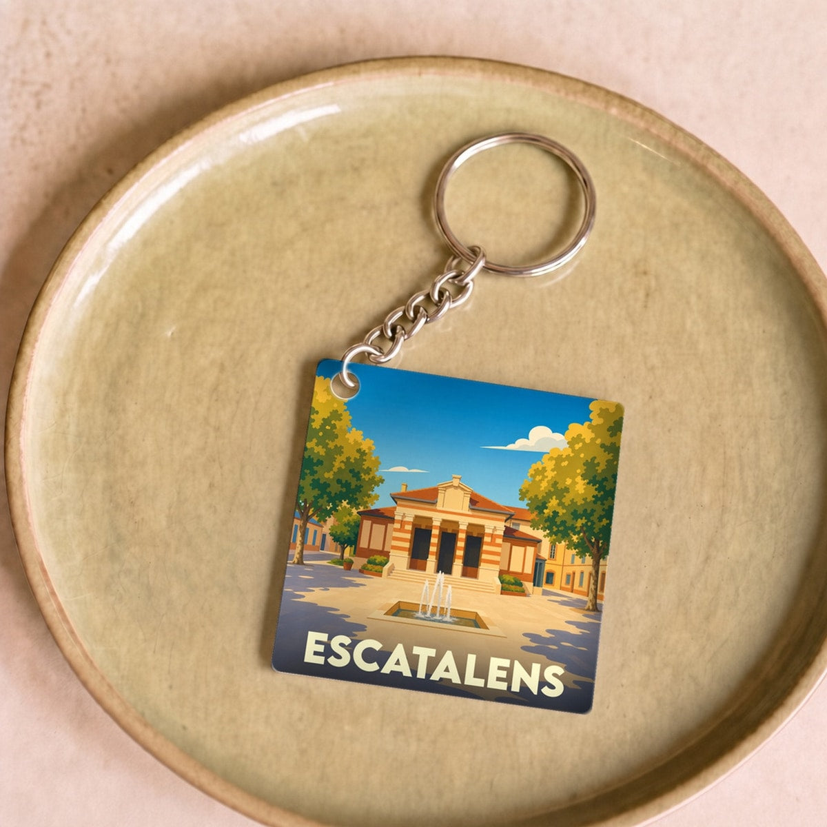 Porte-clés souvenir de la ville d'Escatalens avec une illustration stylisée.