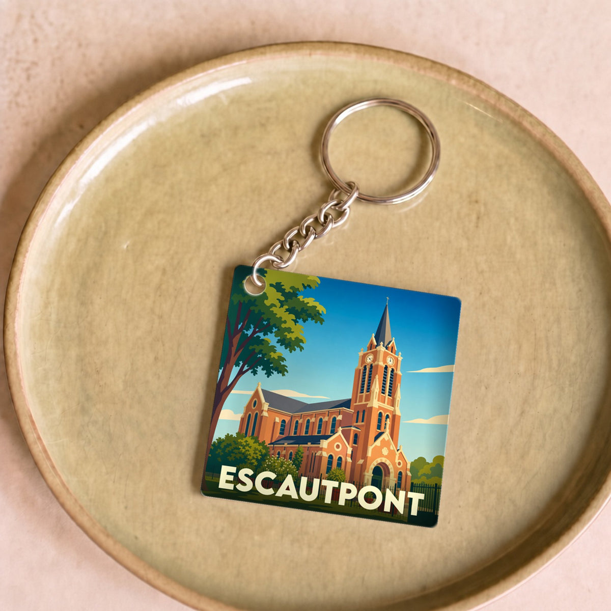Porte-clés souvenir de la ville de Escautpont avec une illustration stylisée de son église.