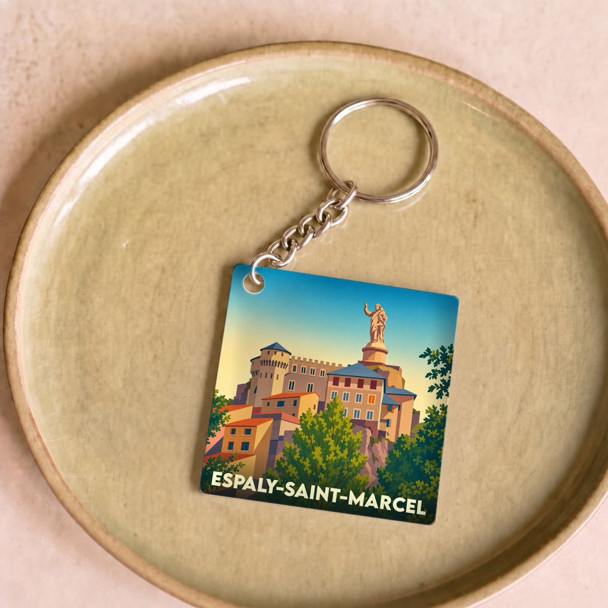 Porte-clés souvenir de la ville de Espaly-Saint-Marcel avec une illustration stylisée.