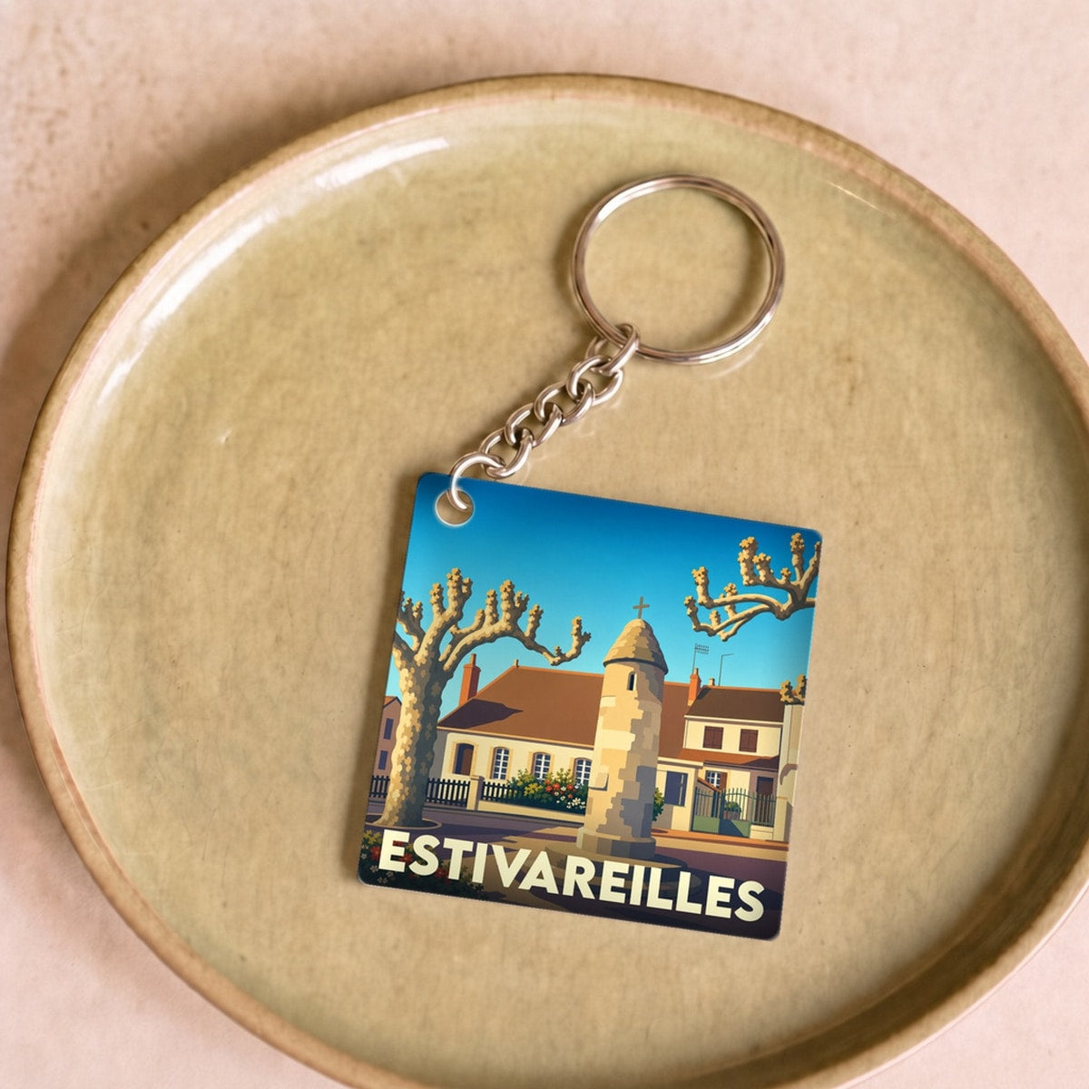 Porte-clés souvenir de la ville d'Estivareilles avec une illustration stylisée.