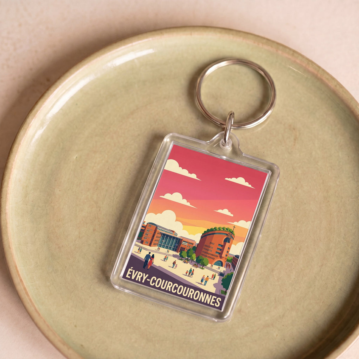 Porte-clés souvenir de la ville d'Évry-Courcouronnes avec une illustration colorée et stylisée.