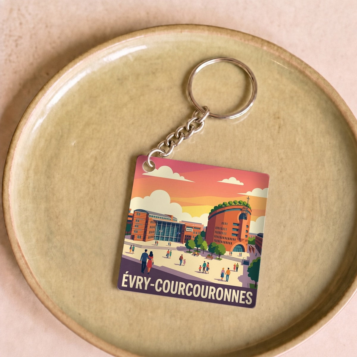 Porte-clés souvenir de la ville d'Évry-Courcouronnes avec une illustration colorée et stylisée.