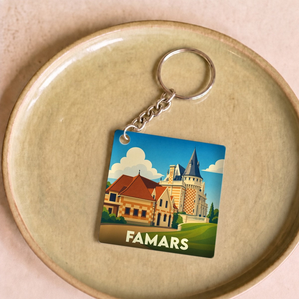 Porte-clés souvenir de la ville de Famars avec une illustration stylisée d'un château.