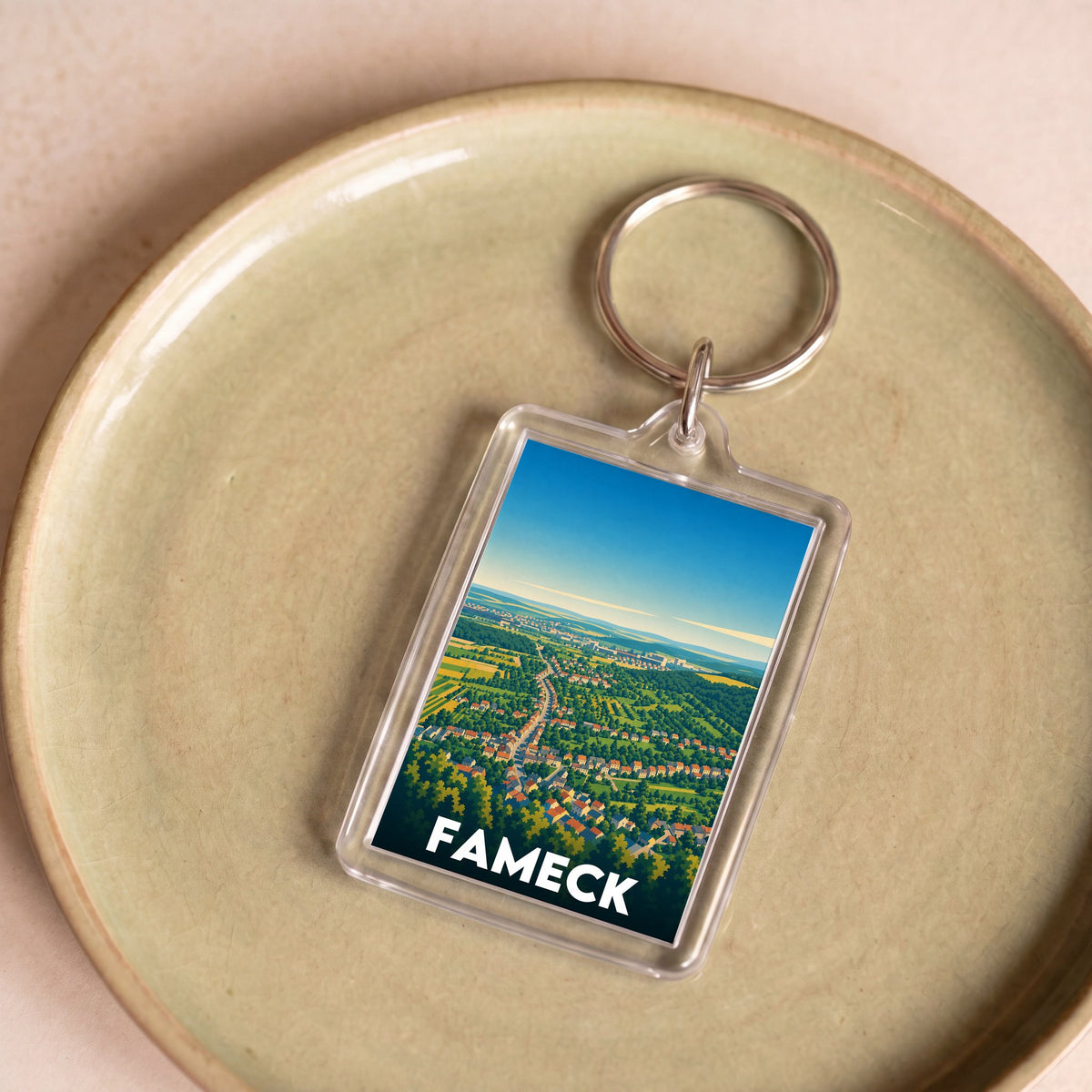 Porte-clés souvenir de la ville de Fameck avec une illustration stylisée.