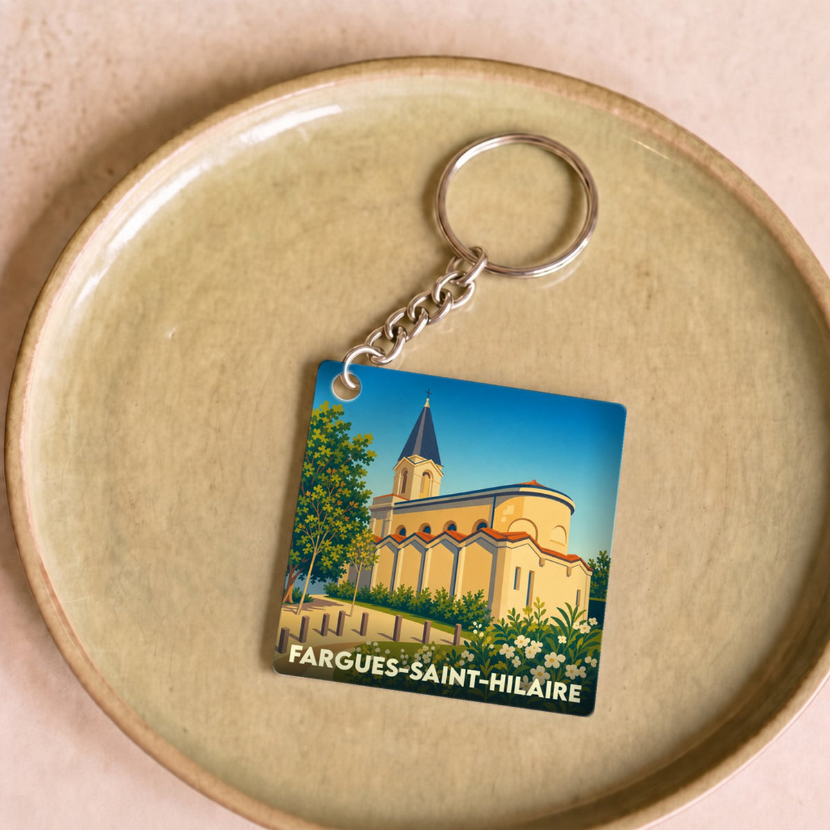 Porte-clés souvenir de la ville de Fargues-Saint-Hilaire avec une illustration stylisée.