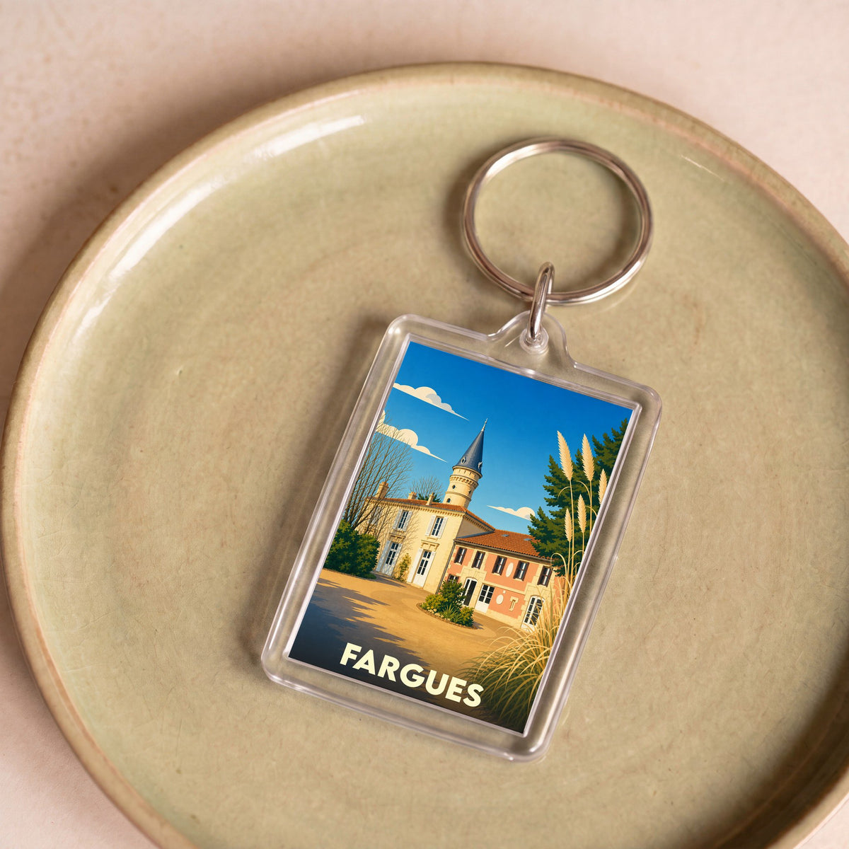 Porte-clés souvenir de la ville de Fargues avec une illustration stylisée.