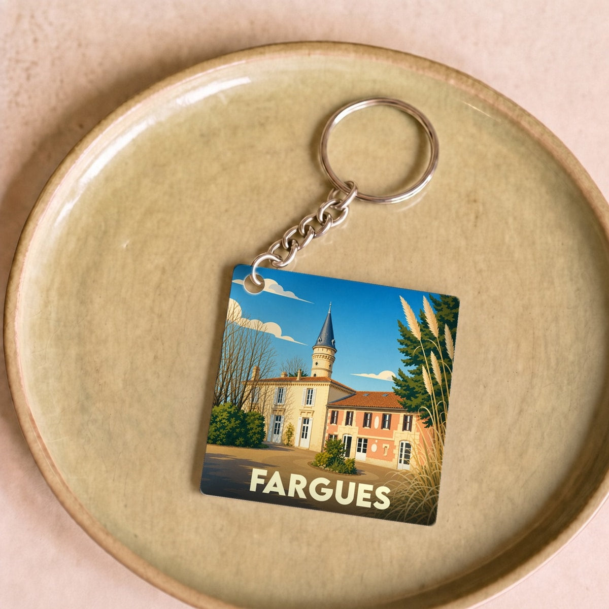 Porte-clés souvenir de la ville de Fargues avec une illustration stylisée.
