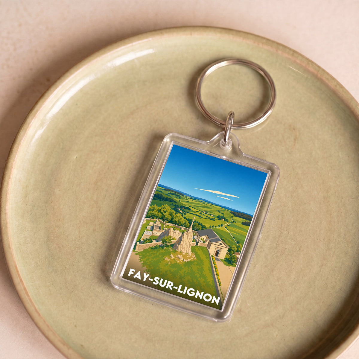 Porte-clés souvenir de la ville de Fay-sur-Lignon avec une illustration stylisée.