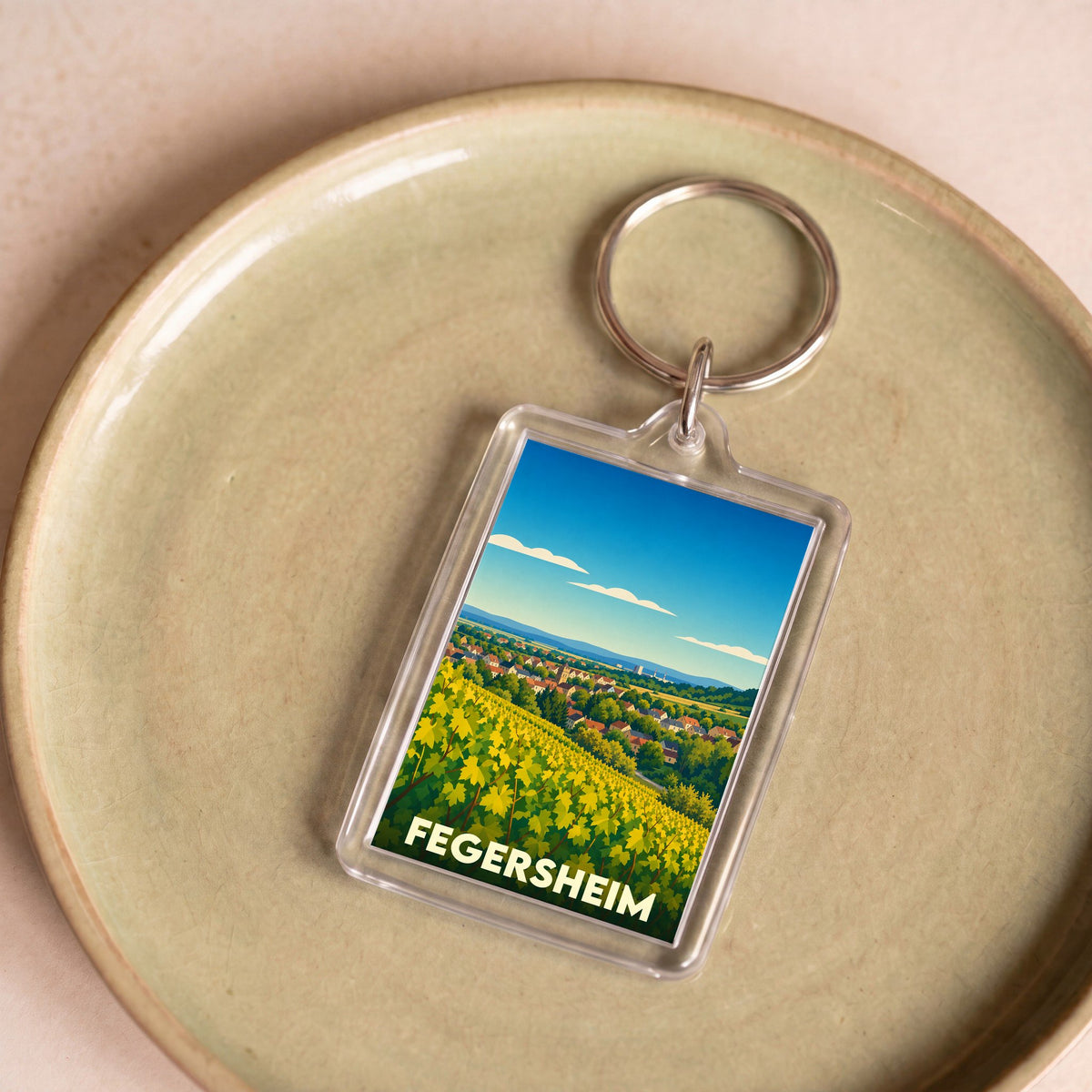 Porte-clés souvenir de la ville de Fegersheim avec une illustration stylisée de vignobles.