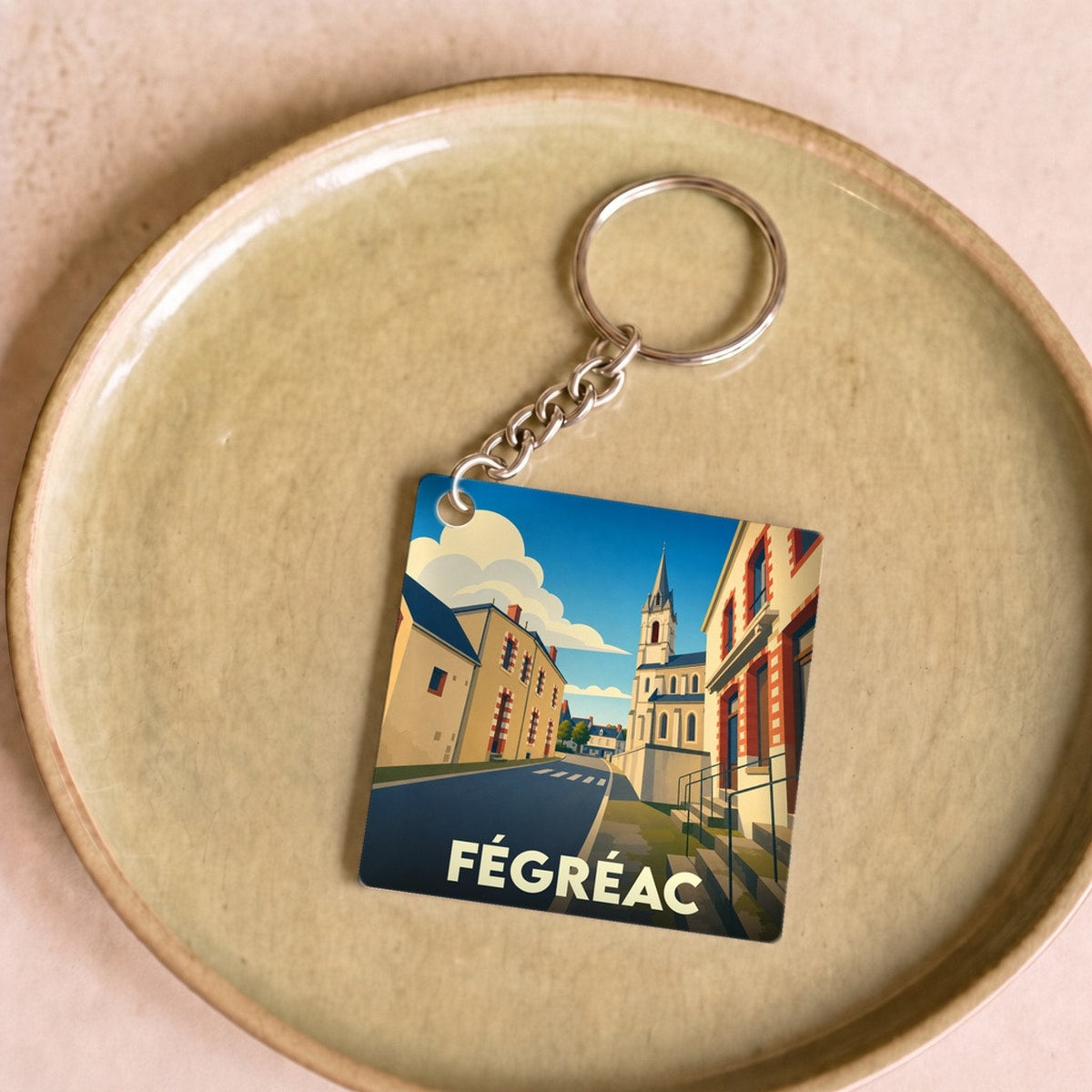 Porte-clés souvenir de la ville de Fégréac avec une illustration stylisée.