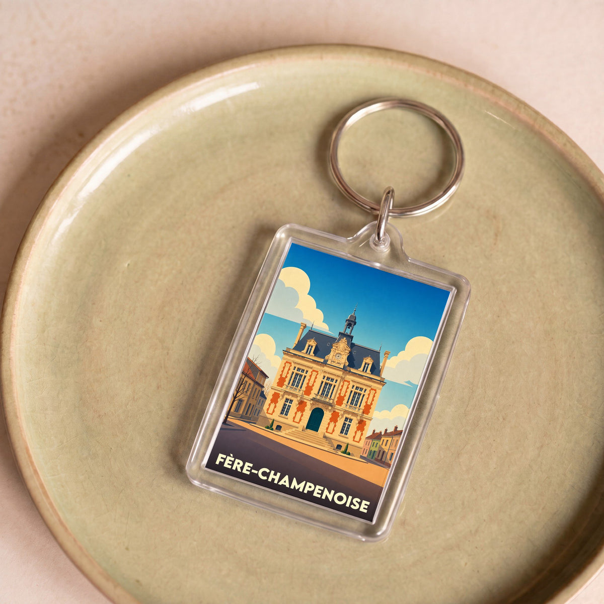 Porte-clés souvenir de la ville de Fère-Champenoise avec une illustration stylisée de son hôtel de ville.